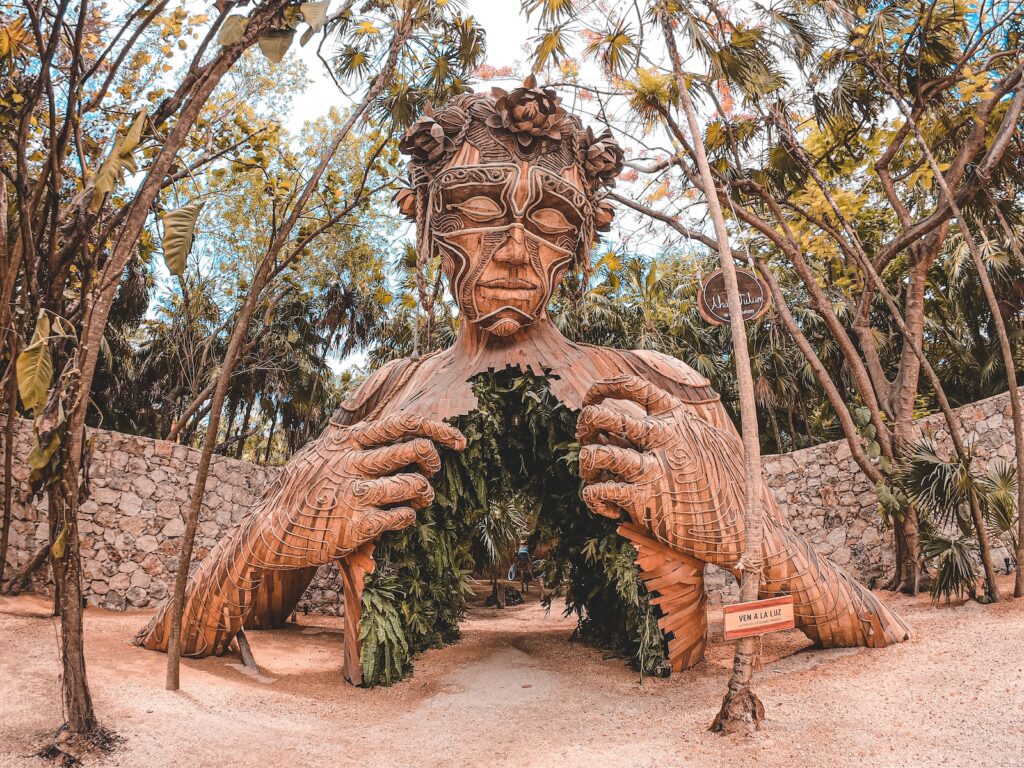 brown wooden statue on brown soil